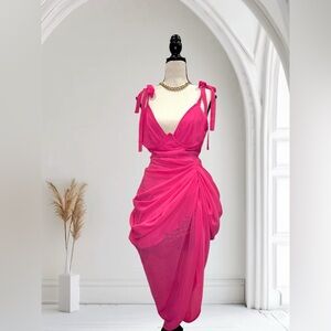 Pink dress with spaghetti straps. Has a sweetheart neckline and a gathered skirt